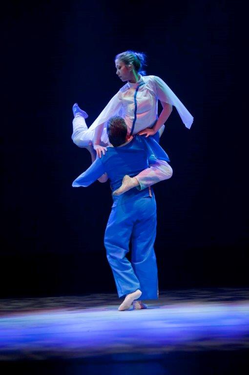 Need descriptions for each of the images       Intermediate Ballet Technique class          dancer flying off back of another dancer          duet using chair as a prop          confetti in air, dancers showing exuberance          dancers in Chinese folk fan dance          dancers making a group shape that is reaching for light          dancers holding umbrellas upward, with delight          duet dancing with sofa          duet in soft blue light, making a pose          dancers on stage in blue light in a lunge          dancers in circle surrounding a soloist          duet dancing in soft blue light in a curved shaped pose          duet in a lift