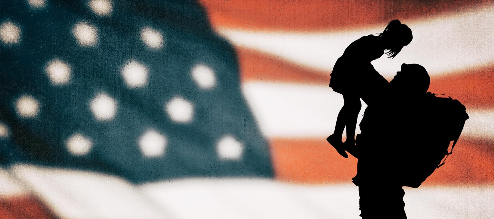 Soldier holding child in front of flag