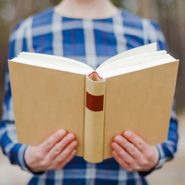 Open book held by student