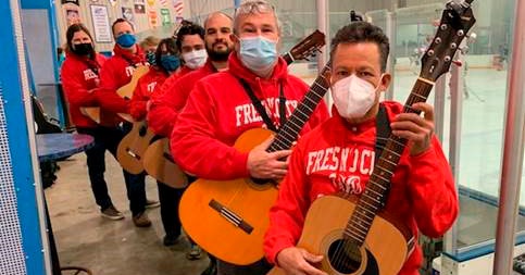 students in a line holding guitars