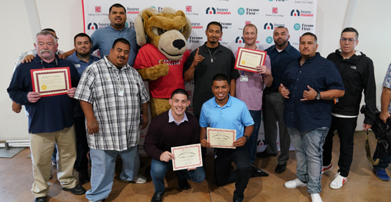 Participants standing with certificate