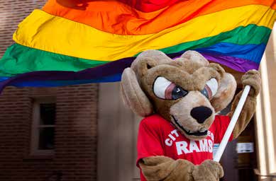 Sam the Ram holding pride flag