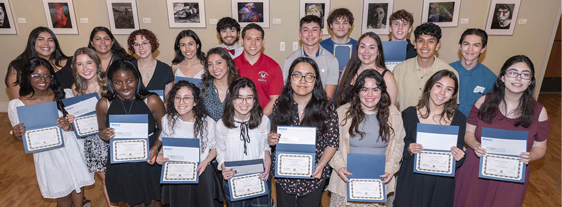 students holding award certificate and check