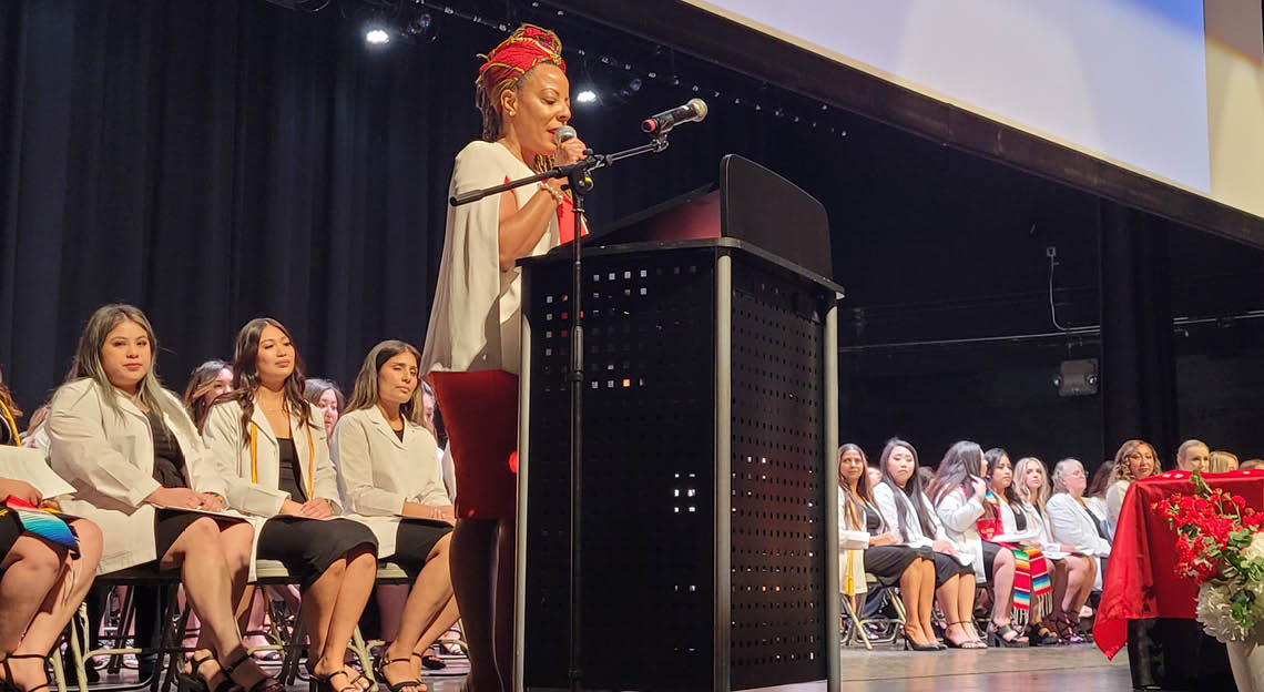 registered nursing pinning ceremony with speaker at podium