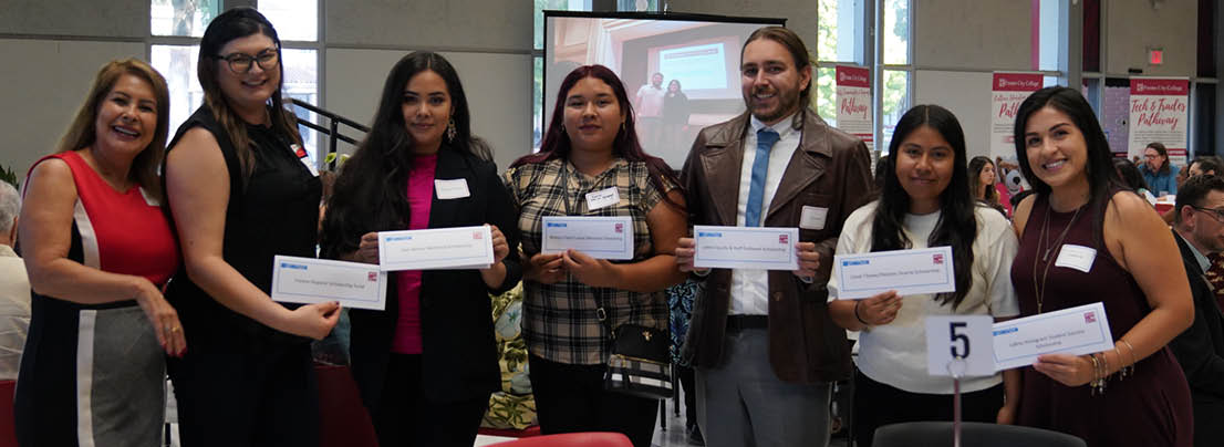 Students holding scholarship checks