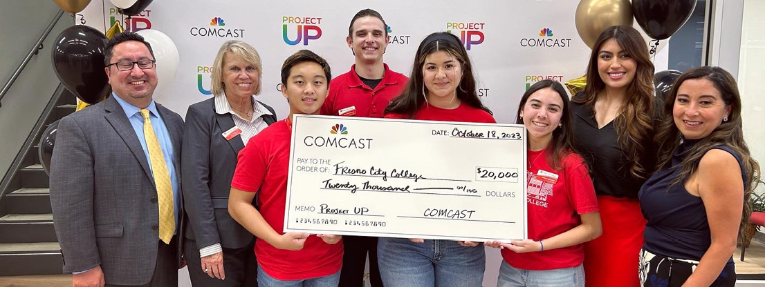 Students holding giant check