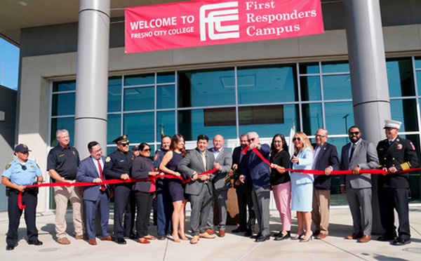 Ribbon cutting ceremony with large scissors