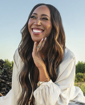 Amber Balakian smiling and sitting outside