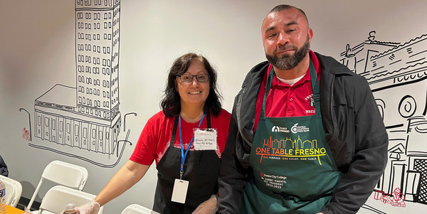 Al Ghadi and Dr. Pimentel wearing food service aprons