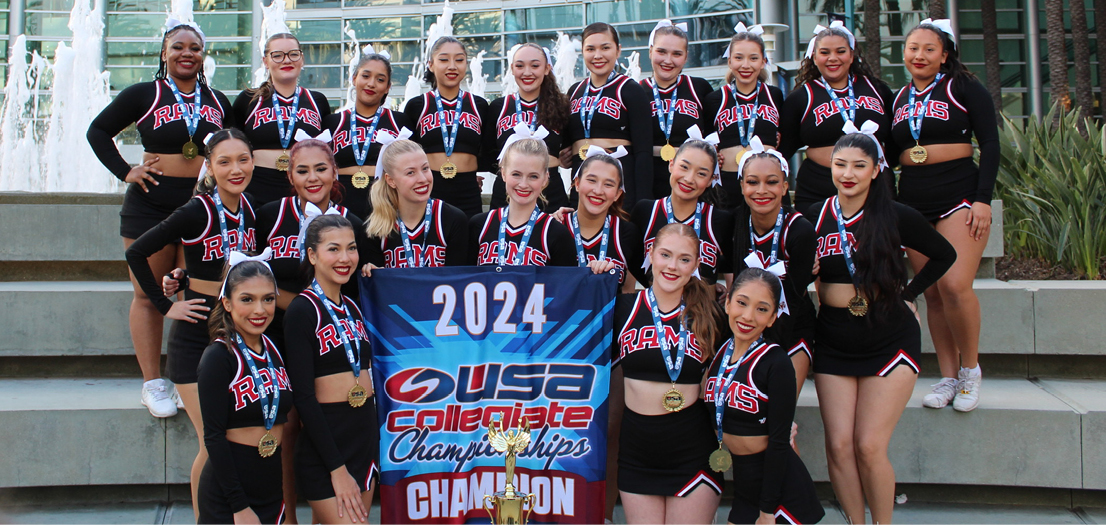 FCC Cheer team holding championship banner