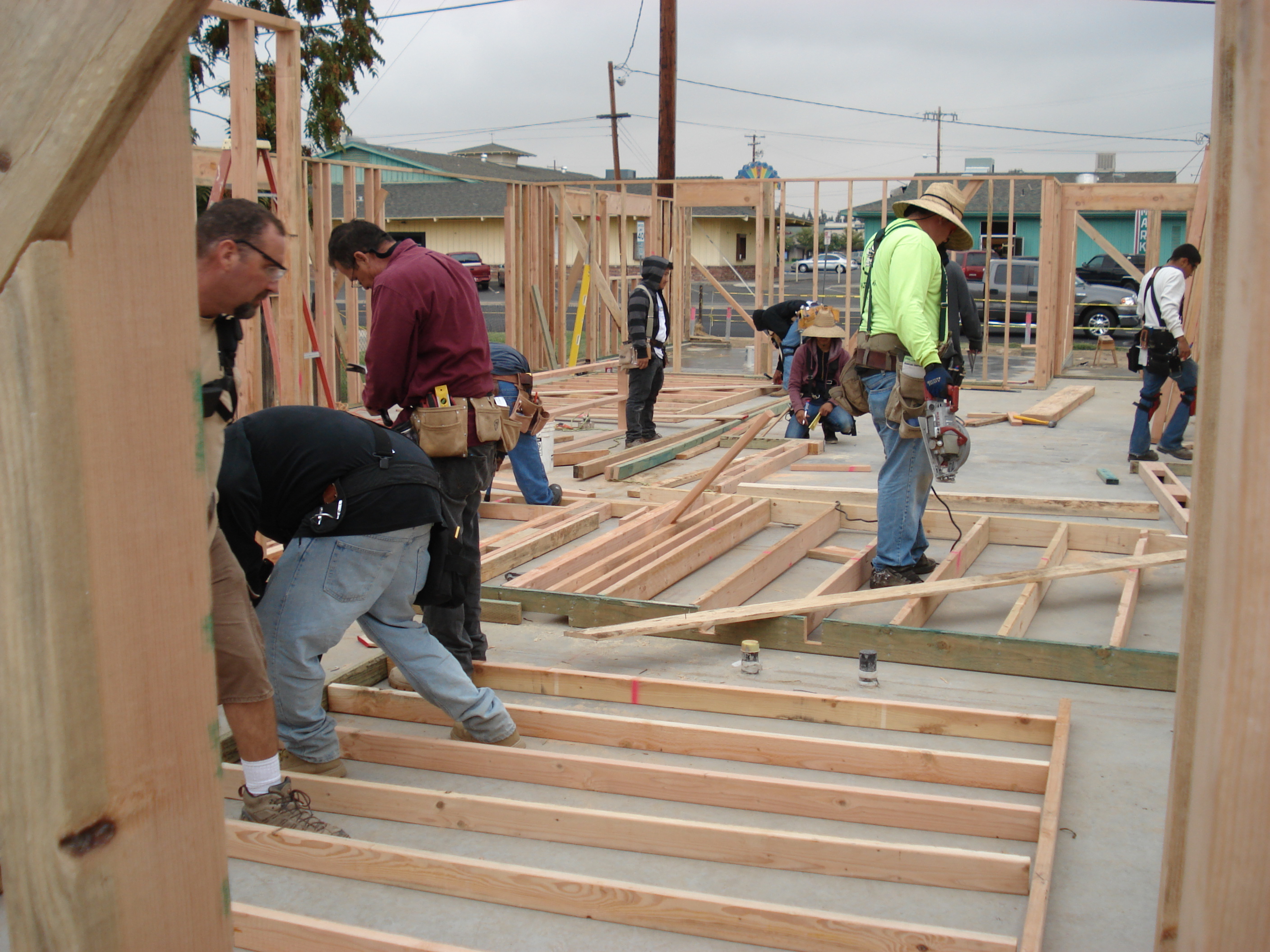 Students Framing a House          Learning to Operate the Saw          Student Constructed Home          Students Finishing Concrete