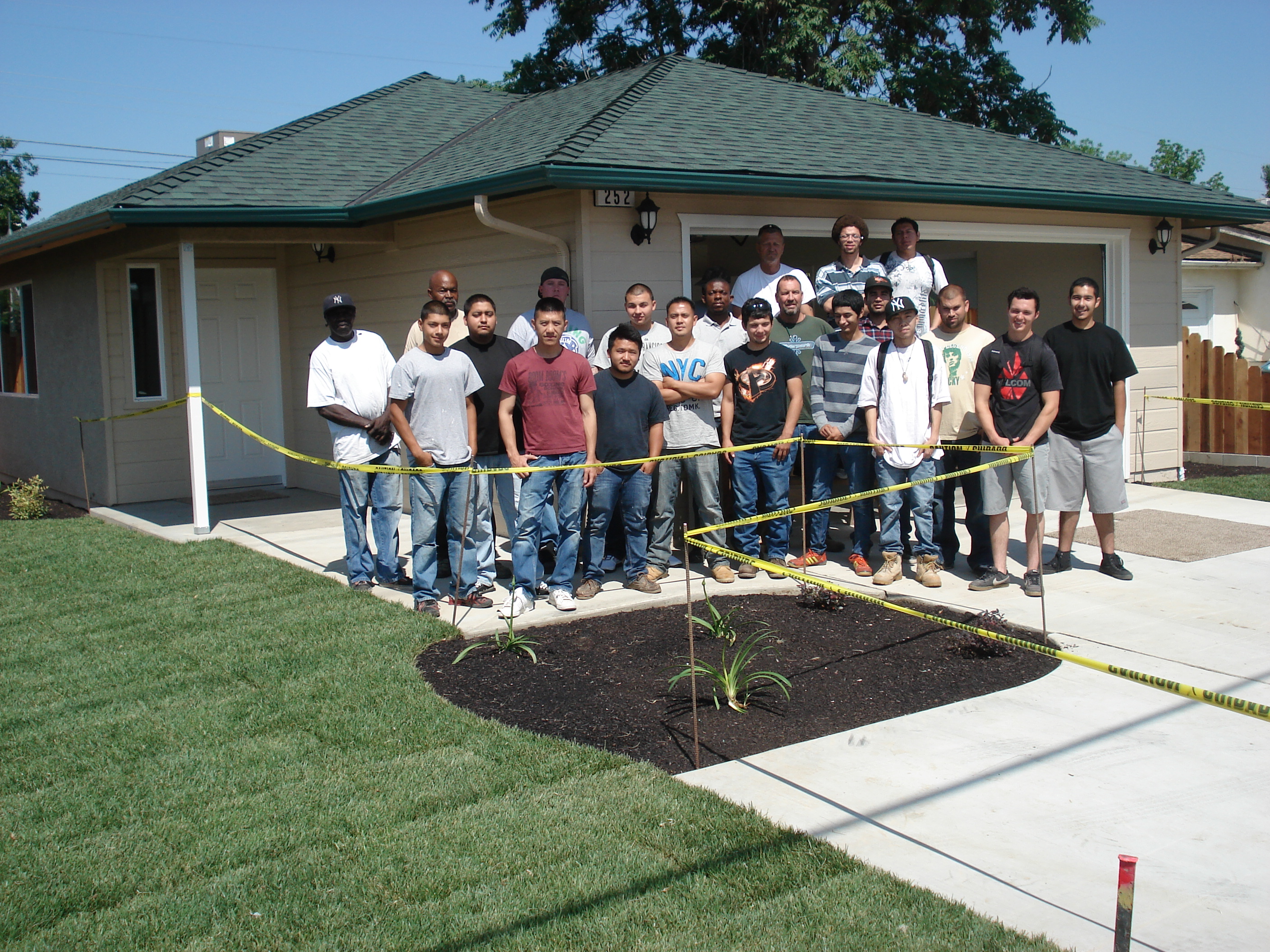 Students Framing a House          Learning to Operate the Saw          Student Constructed Home          Students Finishing Concrete