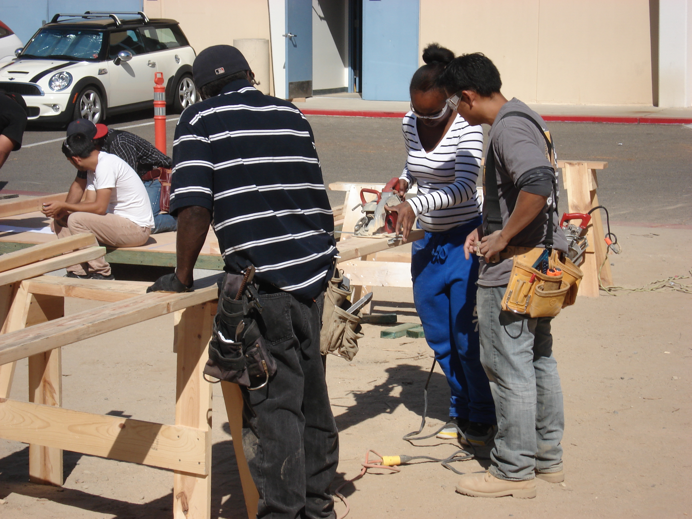 Students Framing a House          Learning to Operate the Saw          Student Constructed Home          Students Finishing Concrete