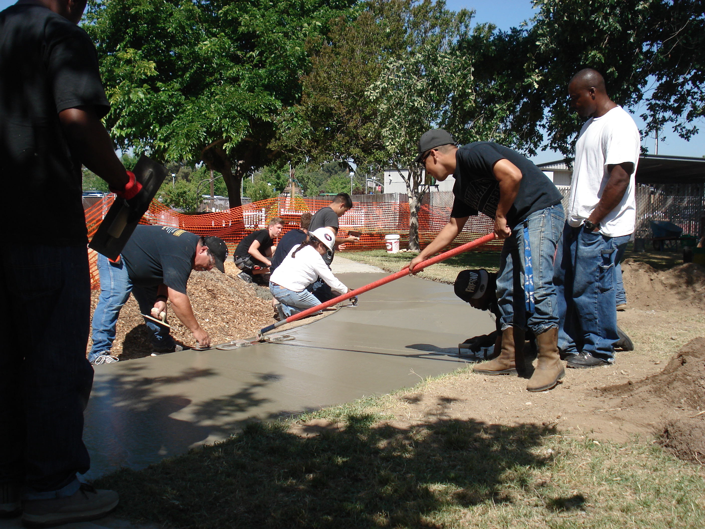 Students Framing a House          Learning to Operate the Saw          Student Constructed Home          Students Finishing Concrete