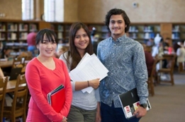 three students in library