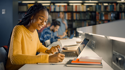 high school student studying in college library