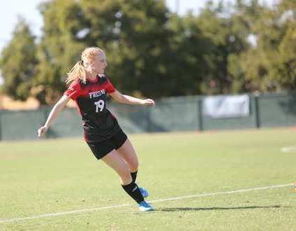 girl kicking soccer ball