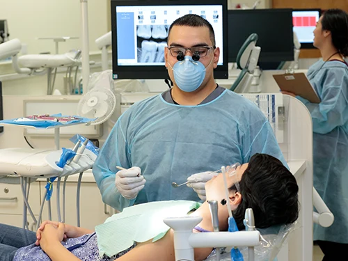 dental students cleaning patients teeth