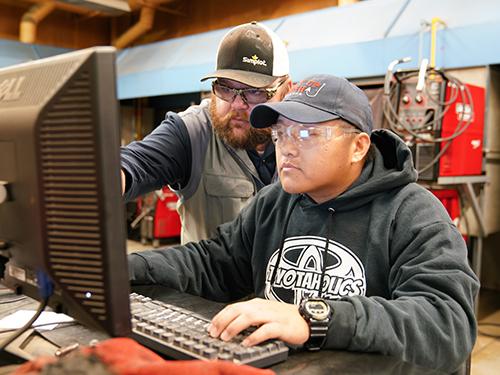 Student and teacher on computer