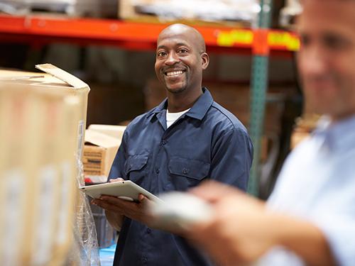 Man smiling while working in warehouse