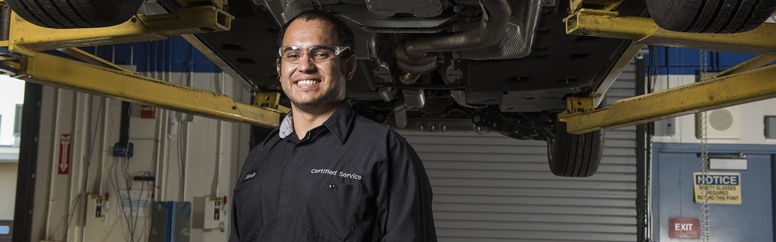 automotive student under car