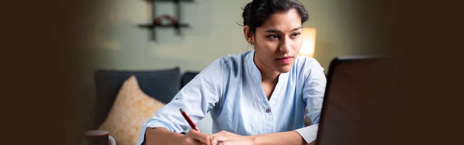 Smiling young woman with open computer