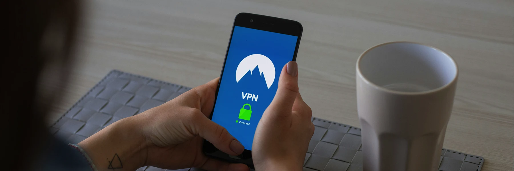 woman looking at phone logging in to VPN