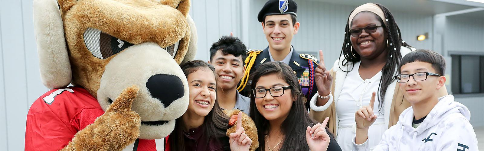 Smiling students with Rocky the Ram mascot