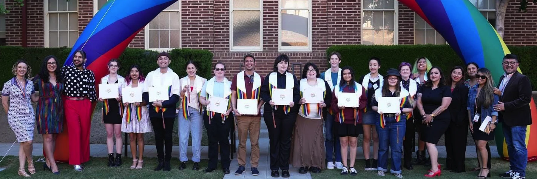 rainbow graduation celebration students with certificates