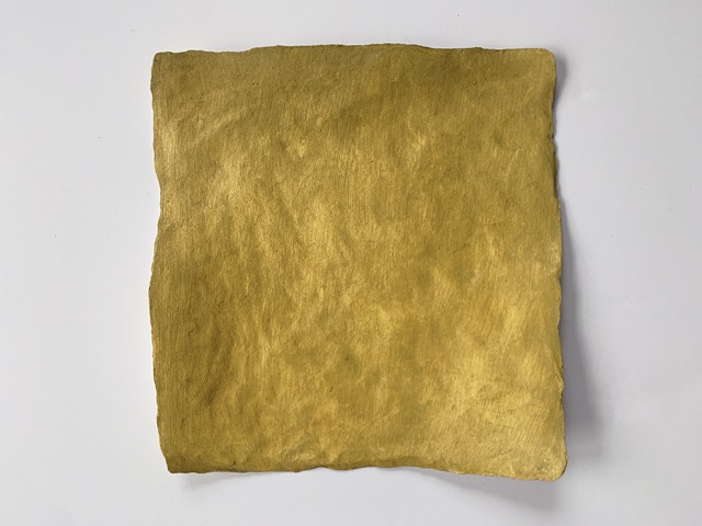 close up image of an irregular square shaped artwork painted in golden yellow oil paint. 
