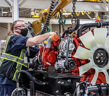 man working on diesel engine