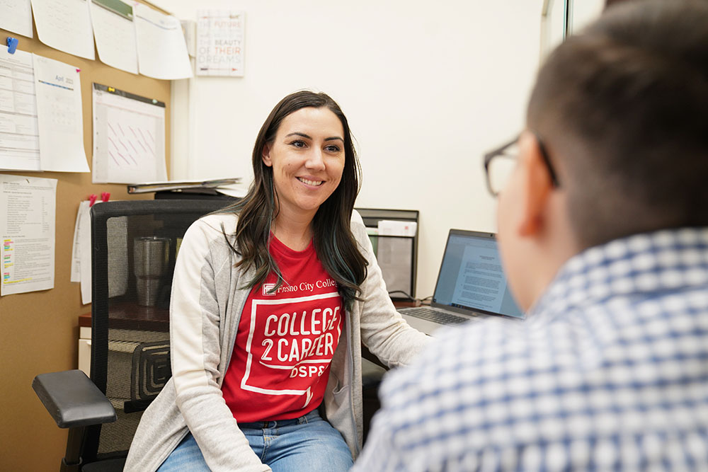 Counselor and student sitting at desk 